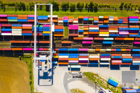  Aerial view of containers at railway. Big container terminal on a railroad with open storage area.