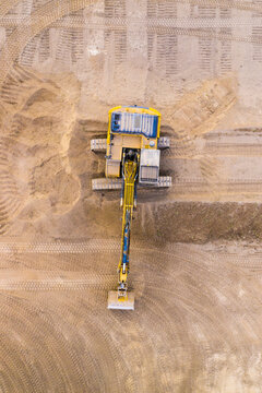 Excavator on a construction site. Aerial view from european industry.