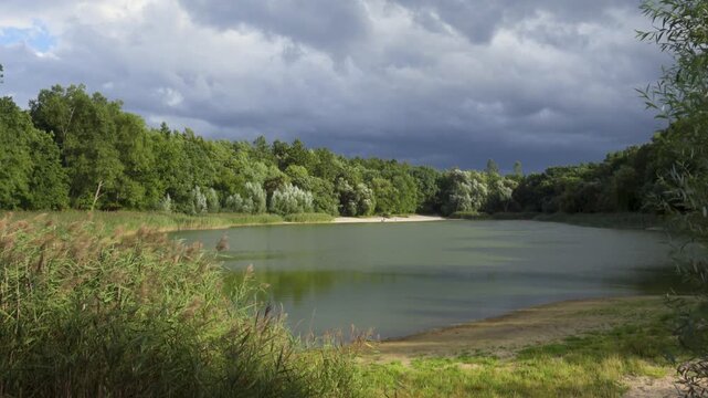 Storm Approaching Lake Goplana in Szczecin Poland, 4K. Wind blowing through the foliage and reeds, with high-quality original ambient sound of the rustling leaves and wind included. 