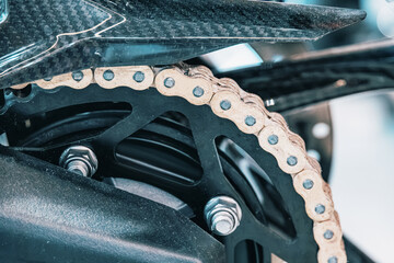 Motorcycle chain and sprocket mechanism, a close up showing mechanical engineering and power transmission in transport