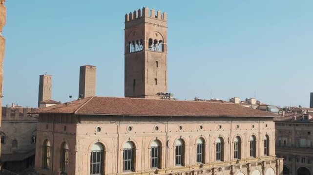 Palazzo del Podesta and medieval Torre dell Arengo on Piazza Maggiore in Bologna old town, Emilia-Romagna, Italy. Historic Italian architecture, medieval palace, brick bell tower, urban tourism