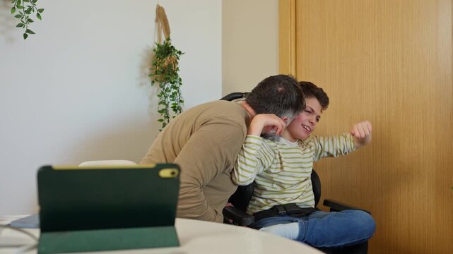 Father showing love and affection to son with cerebral palsy