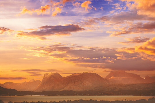 Fjord at dramatic sunset. Rocky seashore in the evening.  Beautiful nature of Norway. Picturesque Scandinavian landscape. Norway