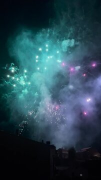 Spectacular fireworks exploding in the night sky over Olot, Spain