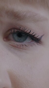 Close-up portrait of unhappy young woman's eyes looking at camera blinking. Negative emotion and face expression concept.