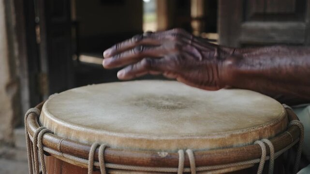Playing musician's hands reaching roped drumhead at porch, tapping making steady rhythm
