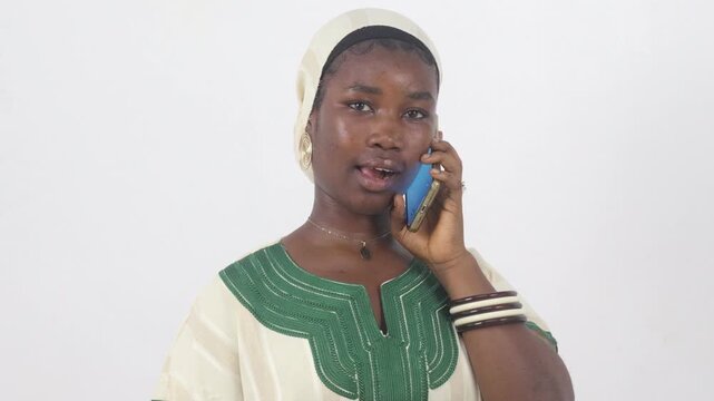 Smiling young woman on the phone pointing at the camera