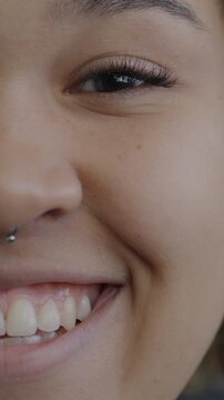 Portrait of joyful African American girl half face laughing on black background. Happy people and human emotion concept.
