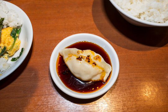 Steamed Dumpling Served With Dark Dipping Sauce