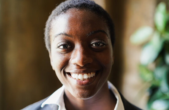 Happy african american business girl smiling on camera inside job office - Work and corporate concept - Focus on face