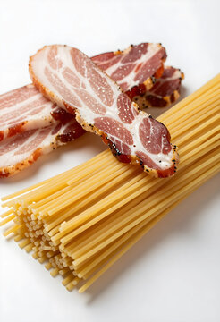 Italian cuisine and culinary tradition, raw spaghetti pasta with slices of cured guanciale or pancetta meat for authentic carbonara preparation