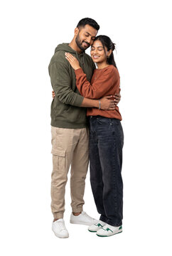 Affectionate young Indian couple in love embracing with eyes closed. Happy romantic man and woman hugging, showing togetherness and support. Isolated full length shot on transparent background.