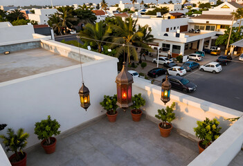 Fototapeta premium Ramadan celebration and evening atmosphere, traditional moroccan lanterns hanging on a rooftop terrace with potted plants in a quiet residential area