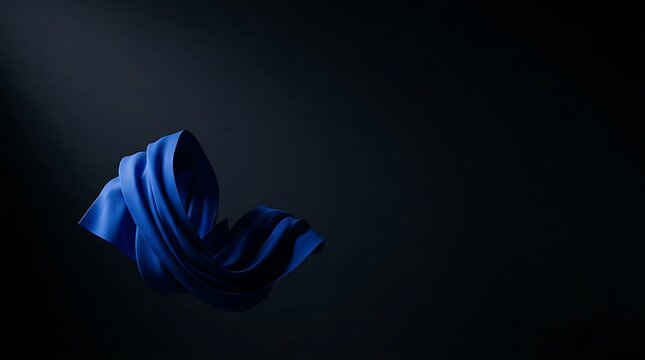 Elegant blue fabric gracefully flowing in a spotlight against a deep, mysterious dark background, creating a serene and dynamic artistic composition, highlighting texture and fluidity