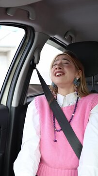 Vertical screen talkative passenger laughs and gestures inside a moving car showing how distracting conversations can reduce driver attention and increase road safety risks