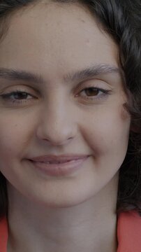 Portrait of young lady smiling expressing joy looking at camera on black background. Positive emotion and face expression concept.