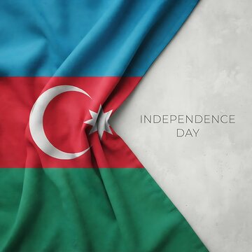 Real Azerbaijan tricolor flag draped on grey concrete background with Independence Day typography and copy space.