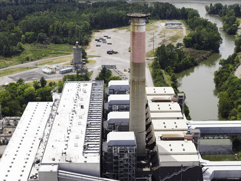 Aerial view of the Gallatin Fossil Plant coal-fired power station, featuring the tall exhaust stack, industrial infrastructure, and surrounding greenery in Gallatin, TN, United States.