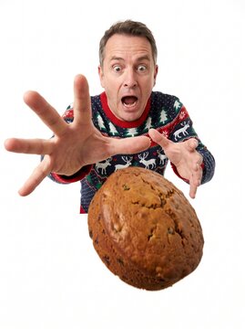 Man in Christmas sweater shocked dropping holiday cake on white