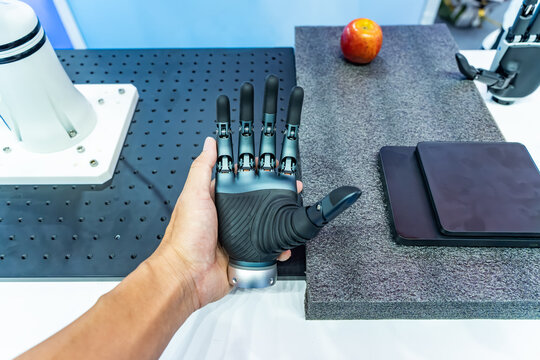 human holding advanced bionic robotic hand showing gesture, symbolizing AI and human collaboration.  