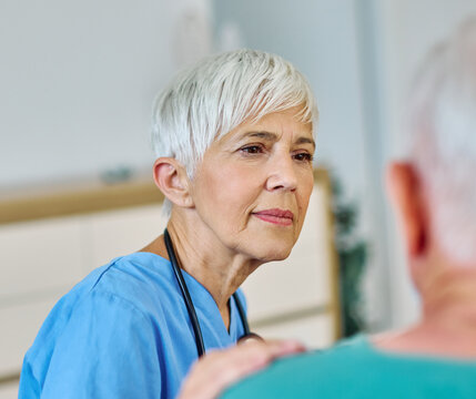Portrait of a doctor or nurse caregiver supporting senior man, hand on the shoulder care and hug at home or nursing home