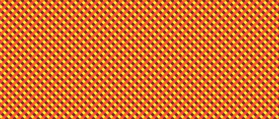 Obraz premium Seamless geometric diamond pattern in red, orange, yellow and brown. Repeating plaid-inspired design. Bold abstract background for fabric, wallpaper, wrapping paper and graphic projects.
