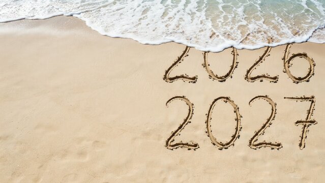 2026 and 2027 written in the sand on a beach with ocean waves