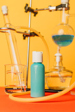 Blue cosmetic cream bottle in colorful chemistry laboratory