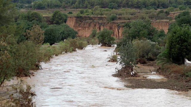 Dangerous river overflowing banks during flash flood