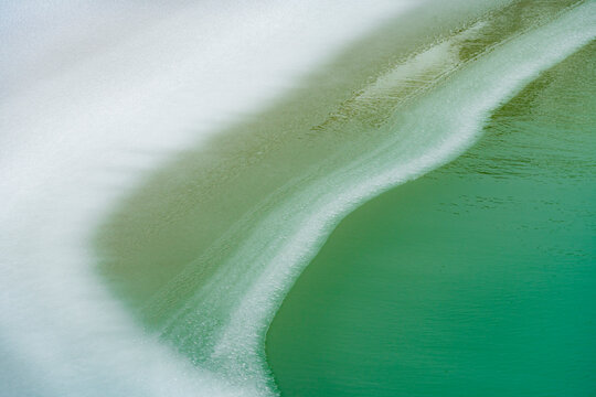 Abstract green ice texture with frozen water surface