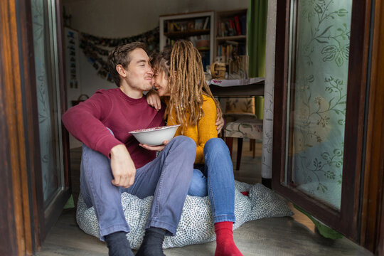 Couple share a tender moment at home with breakfast