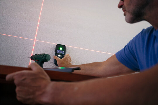 Man use laser level for home renovation project