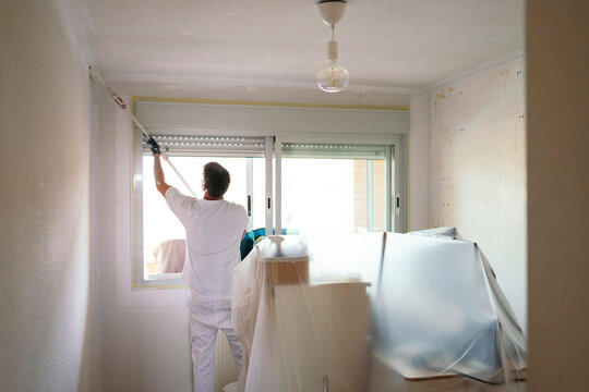 Professional painter preparing room for home renovation