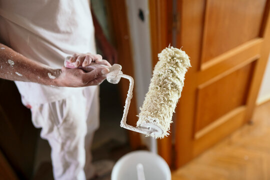 Professional painter prepare roller for interior home renovation