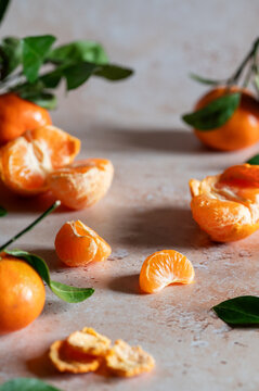Fresh tangerine segments and peel on rustic table