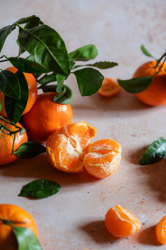 Fresh tangerines with leaves and peeled citrus segments