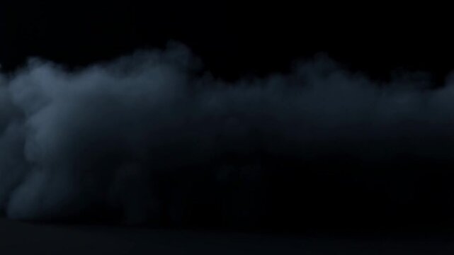 Bluegray smoke spreads and billows across a dark surface against a black background