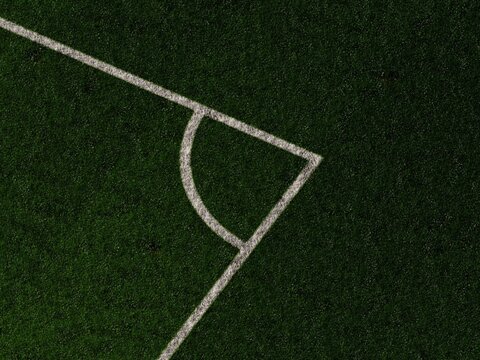 Soccer field corner marking on green grass turf background