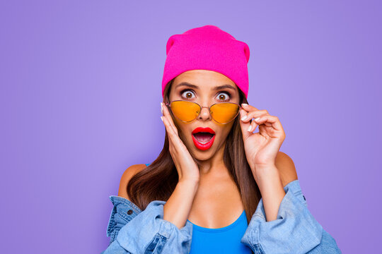 Omg wow! Black friday is here! Close up photo portrait of pretty astonished amazed lady holding spectacles looking at you camera touching cheek isolated bright pastel background