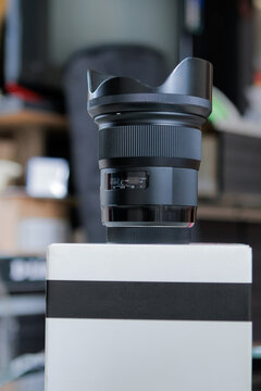 Camera Lens and Packaging Representing Photography Equipment and Camera Gear