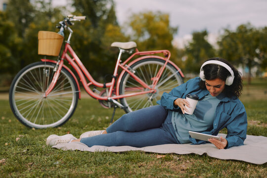 Young woman relaxing in park listening to music
