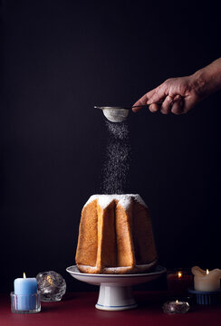 Pandoro star, Christmas Venetian sweet bread in powdered, the symbol of the snow-capped Alpine peaks. Christmas and New Year Italian holidays sweets, festive Italian menu, dark key