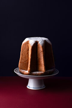 Pandoro star, Christmas Venetian sweet bread in powdered, the symbol of the snow-capped Alpine peaks. Christmas and New Year Italian holidays sweets, festive Italian menu, dark key