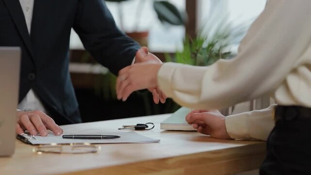 Customer signing paper contract, real estate agent giving home keys, man woman realtor. buy sell flat apartment, property purchasing. Moving to new house, housing service. document bank. handshake