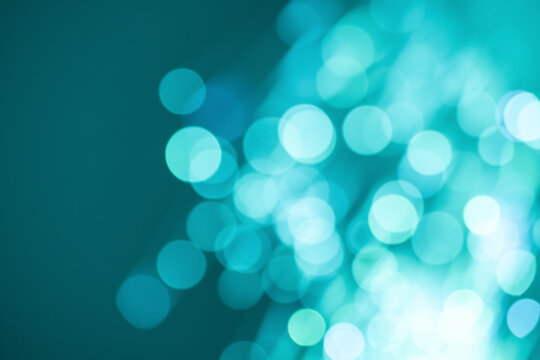 Turquoise bokeh light background with abstract glowing circles
