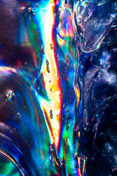 Iridescent water droplet texture with vivid rainbow refraction