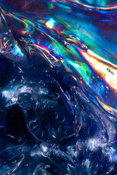 Iridescent ice texture with vivid rainbow light refraction
