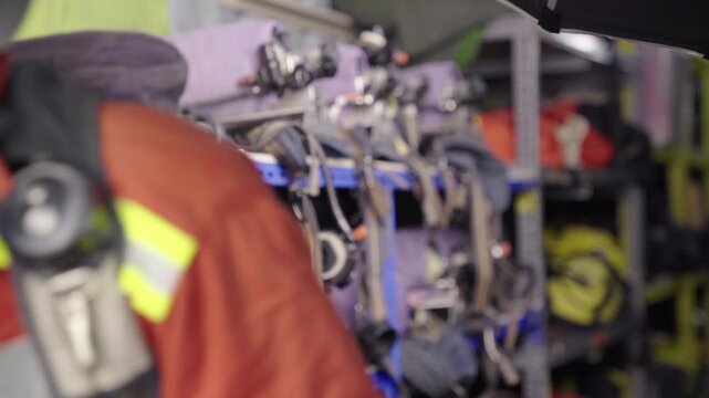 Firefighter equipping full face breathing mask before operation