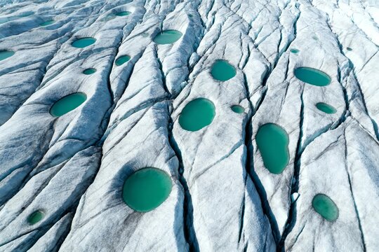 Glacial surface with meltwater pools and crevasses