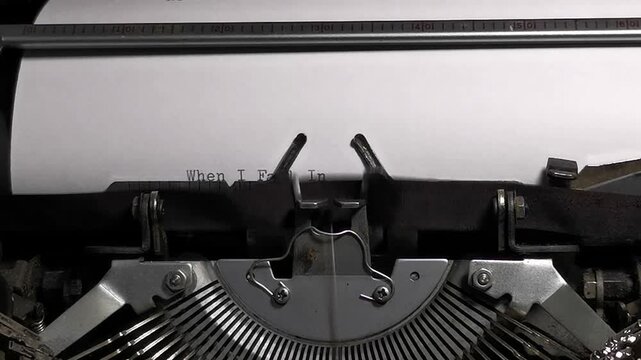 Close Up Overhead Shot of Vintage Typewriter Typing When I Fall In Love